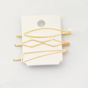 Three-piece set of minimalist gold geometric hair clips with a single pearl accent