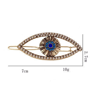 Detail view showing dimensions 7cm by 2.7cm of the rhinestone evil eye hair clip
