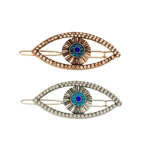 Detailed view of silver and rose gold Evil Eye hair clips with sparkling rhinestones