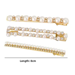 Lot de trois barrettes dorées de 8cm avec perles blanches et strass brillants en détail