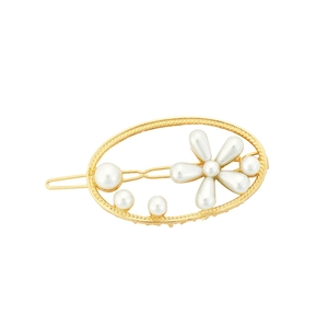 Minimalist gold geometric hair clip with white pearls and flower design on white background