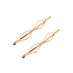 Close-up of golden geometric rhombus hollow hair clips with metallic luster on white background