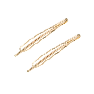 Close-up of two wavy golden metal hair pins featuring a smooth polished finish