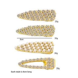 Detailed set of four 8cm gold hair clips with rhinestones and faux pearls for women