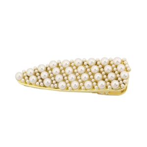 Detailed view of the gold metal hair clip with pearls in a teardrop shape pattern