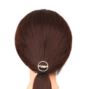 Fashionable golden alloy round hair tie with white pearls on brown ponytail