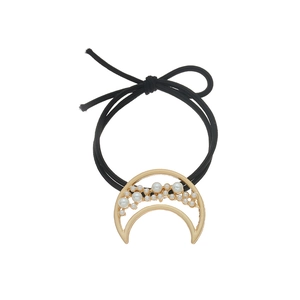 Fashionable moon pearl hair tie with gold alloy frame and black elastic band on white background