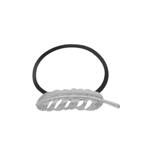 Close-up of silver feather metal detail on elastic hair tie with fine vein textures