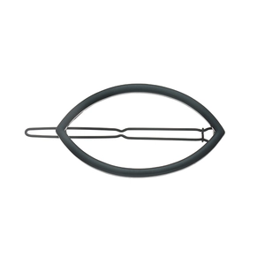 Detail view of the black metal hair clip featuring a minimalist hollow leaf shape and wave pin