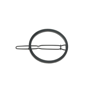 Macro detail of minimalist black matte alloy geometric circle hair clip with wave pin