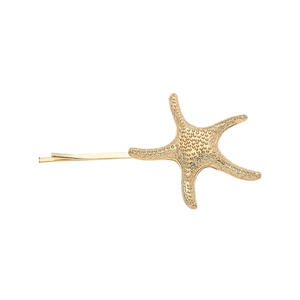 Golden starfish hair clip with textured alloy surface and minimalist summer beach style