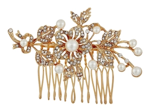 Close-up of golden bridal hair comb with pearls and rhinestones on white background