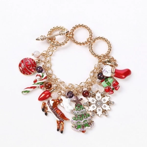 Christmas charm bracelet with snowflakes, Santa, and tree pendants on golden chain