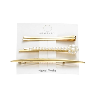 Three-piece gold alloy hair clip set with white pearls on a jewelry display card