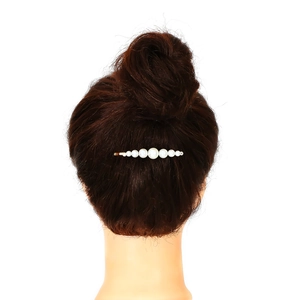 Elegant pearl hair clip set with golden alloy base worn on a stylish bun hairstyle
