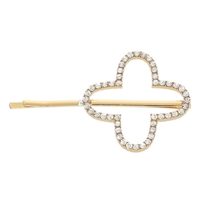 Detail of a golden alloy hair clip featuring a sparkling clover flower with rhinestones