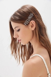 Detail view of Feelings letter hair clip with sparkling rhinestones on a silver alloy base