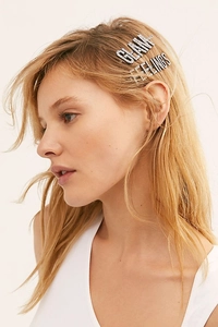 Detail of GLAM and FEELINGS rhinestone hair pins worn on a blonde model side profile