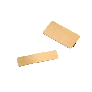 Minimalist gold geometric metal hair clip set with a brushed finish on a white background