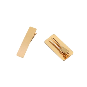 Minimalist gold rectangular metal hair clips set with brushed finish on white background