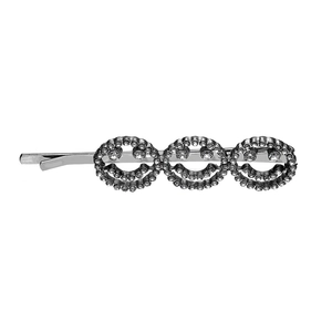 Macro detail of silver alloy hair clip featuring three sparkling rhinestone smiling faces