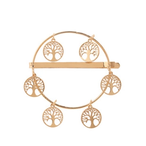Détail d'une pince à cheveux dorée avec cadre circulaire et pendentifs arbre de vie