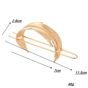 Detail view of a vintage gold leaf hair pin with dimensions and U-shaped metal fork