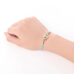 Minimalist evil eye bracelet with blue stones and gold-plated diamond-set pendant