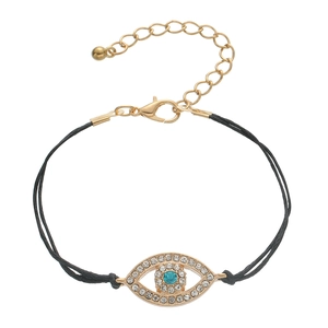 Detail of blue evil eye charm with crystal pavé and black double cord bracelet