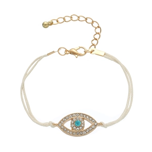 Detail of blue evil eye charm bracelet with clear crystals and adjustable cream woven cord