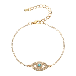 Minimalist gold evil eye bracelet with blue crystal and pave rhinestones on white background