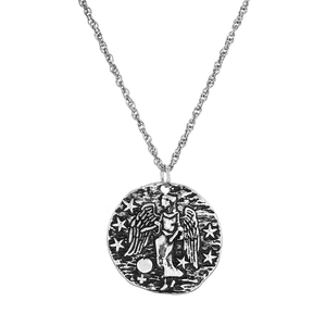 Macro d'un pendentif ange en relief argenté rétro sur une fine chaîne collier