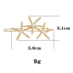 Golden starfish hair clip with white pearls and detailed metal texture, 5.6cm length