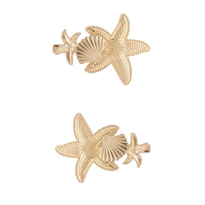 Detail view of golden alloy starfish and seashell hair pins with metallic texture