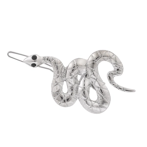 Vintage silver snake hair clip with scale texture and black gemstone eyes on white background