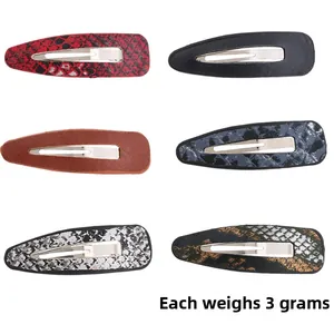 Detail of 6-piece leopard and snakeskin print PU leather hair clips weighing 3g each