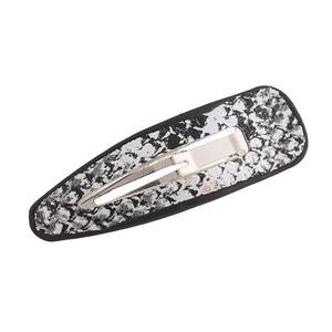 Detailed macro view of black and silver textured snake pattern PU leather BB hair clip
