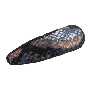 Detailed macro view of snakeskin textured PU leather on a vintage drop hair clip