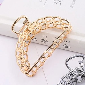 Detail of metal hair claw clips in gold and silver with hollow chain design