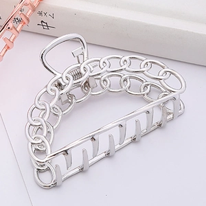 Detailed macro shot of silver hollow chain metal hair claw clip with polished surface