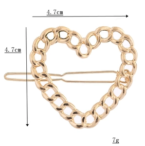 Détail d'une pince à cheveux cœur doré ajouré avec dimensions de 4,7 cm x 4,7 cm