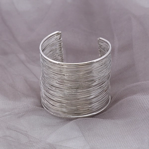 Silver multi-layer wire wrapped open cuff bracelet with a minimalist industrial design