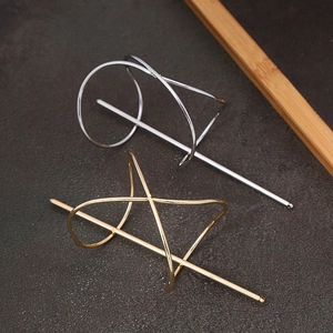 Detailed view of geometric metal hair sticks in gold and silver elegant finishes