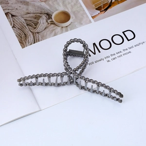Detail of large gunmetal twisted hair claw clip with a secure metal spring mechanism