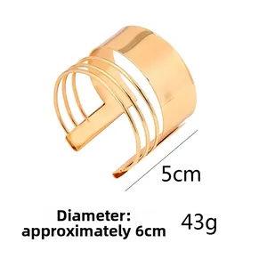 Detail view of gold metal cuff bracelet showing 5cm width and 6cm diameter dimensions