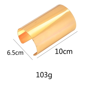 Detailed view of large wide polished gold bangle showing dimensions 10cm by 6.5cm