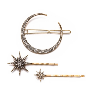 Vintage gold star and moon hair clip set with sparkling rhinestones on white background