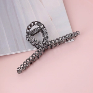 Detailed macro view of gunmetal chain link hair claw clip with metallic spring