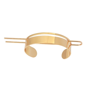 Minimalist gold metal hair pin with polished semi-circular cuff for elegant ponytails