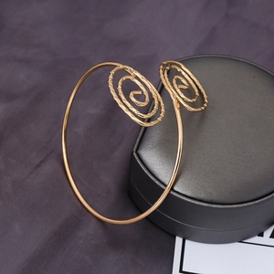 Bohemian gold plated spiral arm cuff with textured leaf design and open spiral ends